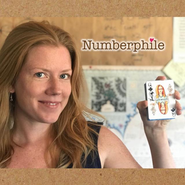 Dr. Krieger holding up some cards with "Numberphile"