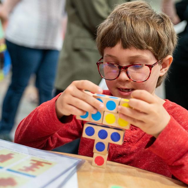 boy playing with colorful wood blocks at 2019 festival
