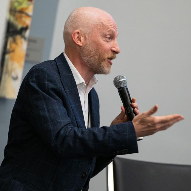 Marcus du Sautoy speaking into microphone at 2019 festival