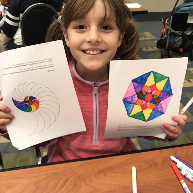 Girl holding mathematical coloring page - National Math Festival 2019
