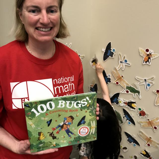 Mathical Author Kate Narita holding 100 Bugs: A Counting Book - National Math Festival 2019
