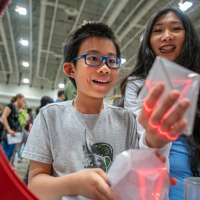 Boy playing with block and laser at 2019 Festival