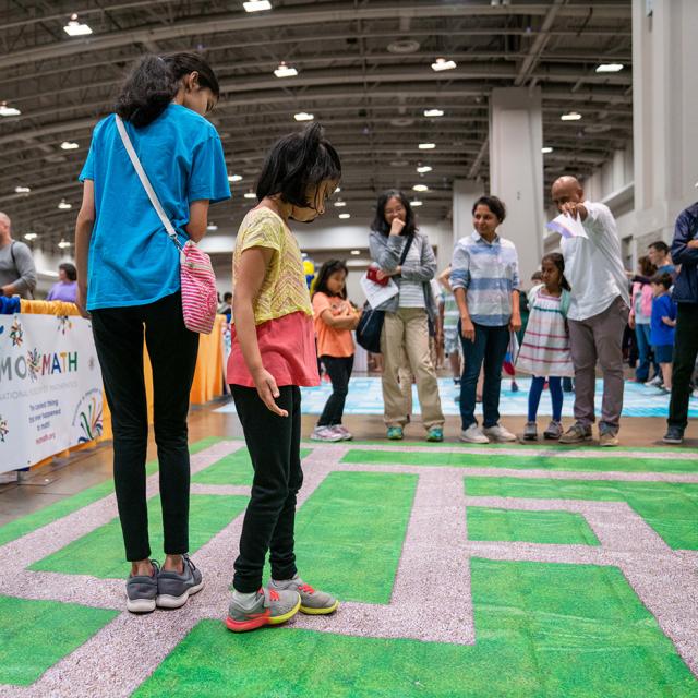 Girl walking on activity mat at 2019 festival