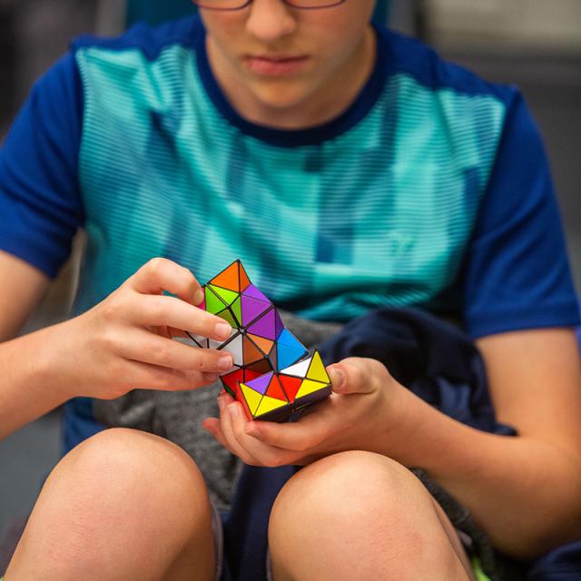 2019 Festival attendee focused on puzzle cube
