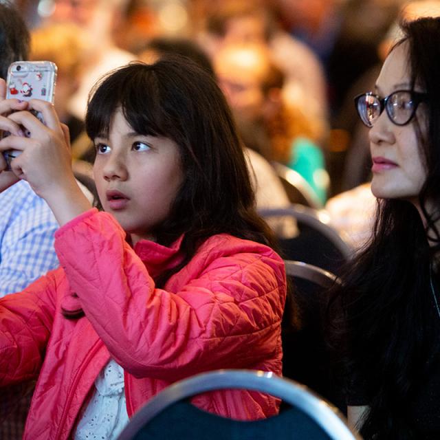 girl in audience takes picture - 2019 National Math Festival