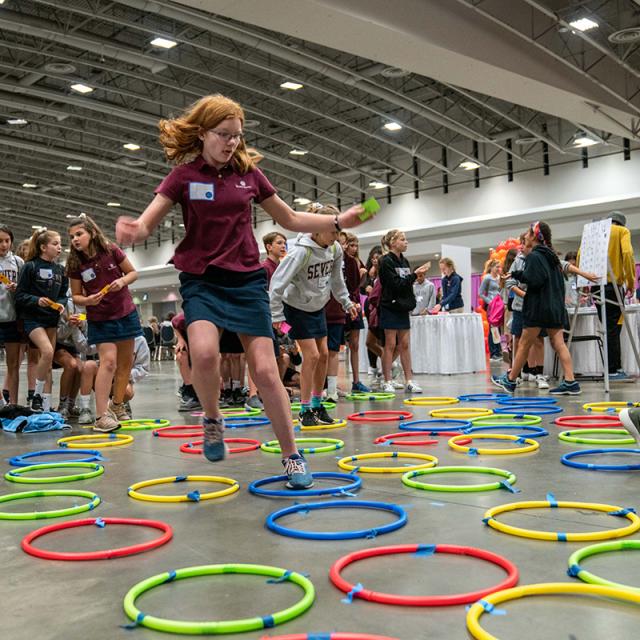 Girl jumping in hoops on the floor at 2019 Festival