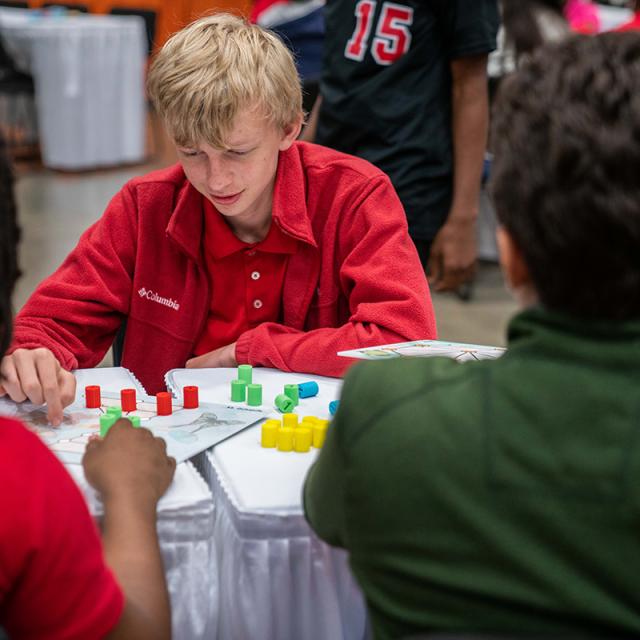 Boy with colorful game pieces at 2019 festival